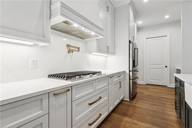 104 Tucker Ct, Carrollton, VA 23314 - kitchen with custom range hood, appliances with stainless steel finishes, light countertops, dark wood-style floors, and recessed lighting