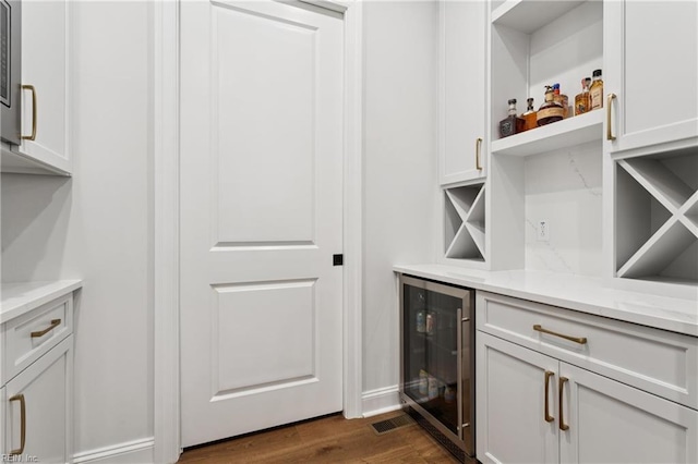 104 Tucker Ct, Carrollton, VA 23314 - indoor dry bar with wine cooler and dark wood-style floors