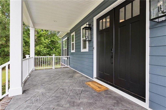104 Tucker Ct, Carrollton, VA 23314 - view of exterior entry with a porch