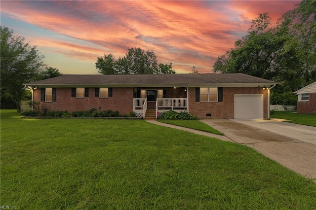 16 Inglewood Dr, Hampton, VA 23666 - ranch-style house with a porch, concrete driveway, a garage, brick siding, and a front yard
