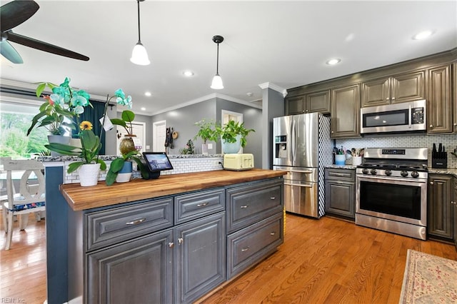 16 Inglewood Dr, Hampton, VA 23666 - kitchen featuring appliances with stainless steel finishes, wood counters, decorative backsplash, crown molding, and light wood-style floors