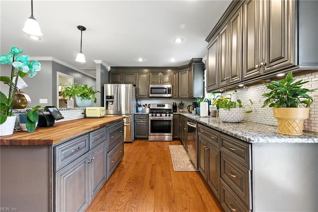 16 Inglewood Dr, Hampton, VA 23666 - kitchen featuring wood counters, appliances with stainless steel finishes, light wood-style flooring, tasteful backsplash, and pendant lighting