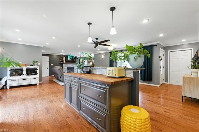 16 Inglewood Dr, Hampton, VA 23666 - kitchen with butcher block countertops, ceiling fan, crown molding, a fireplace, and recessed lighting