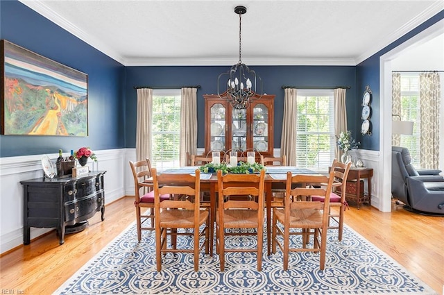 101 Ryder, Smithfield, VA 23430 - dining area featuring healthy amount of natural light, a chandelier, light wood-type flooring, a wainscoted wall, and crown molding