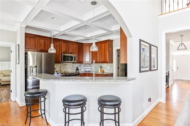101 Ryder, Smithfield, VA 23430 - kitchen featuring appliances with stainless steel finishes, light wood finished floors, beamed ceiling, a breakfast bar area, and tasteful backsplash