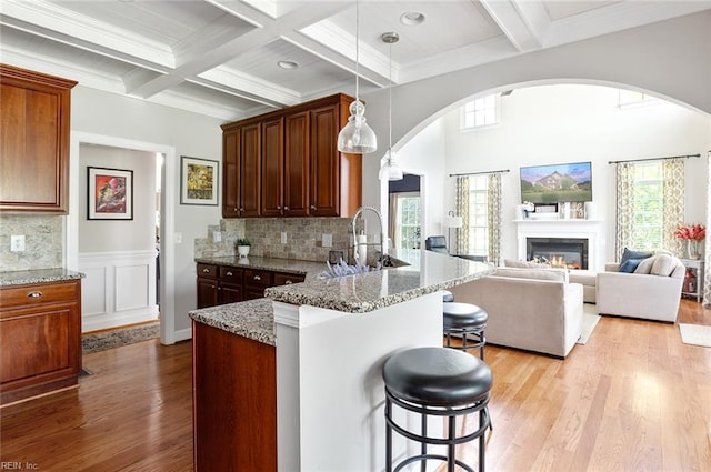 101 Ryder, Smithfield, VA 23430 - kitchen with arched walkways, a breakfast bar, wood finished floors, plenty of natural light, and beamed ceiling