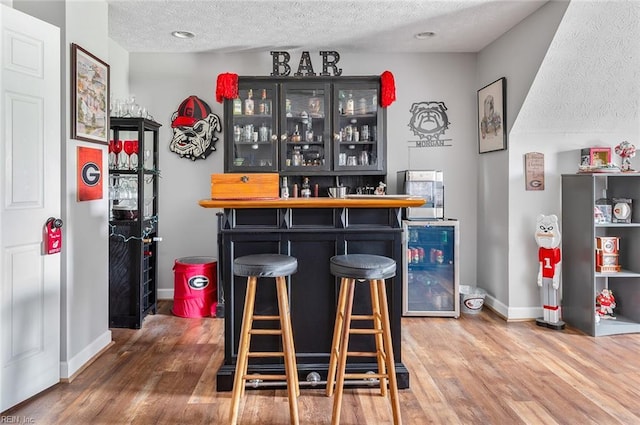 101 Ryder, Smithfield, VA 23430 - indoor dry bar featuring a textured ceiling, wood finished floors, and beverage cooler