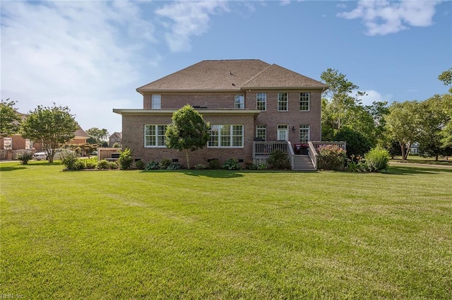 101 Ryder, Smithfield, VA 23430 - back of house featuring brick siding, a lawn, a wooden deck, and crawl space