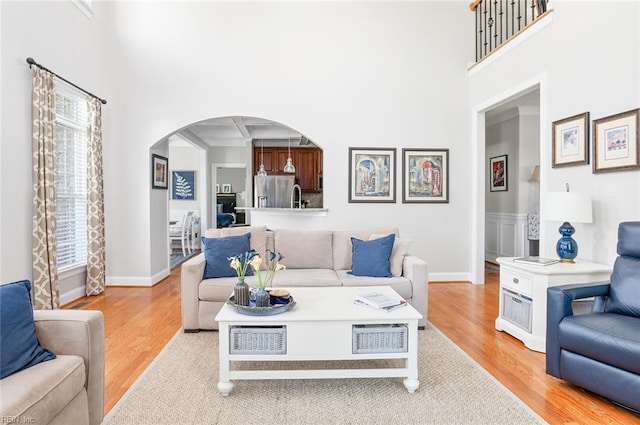 101 Ryder, Smithfield, VA 23430 - living area featuring arched walkways, light wood-style floors, coffered ceiling, and beam ceiling