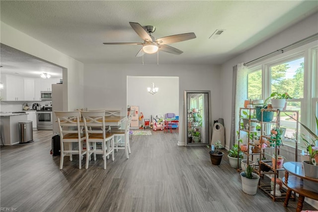 2028 Hickorywood Dr, Suffolk, VA 23434 - dining room with wood finished floors, ceiling fan, a chandelier, and a textured ceiling