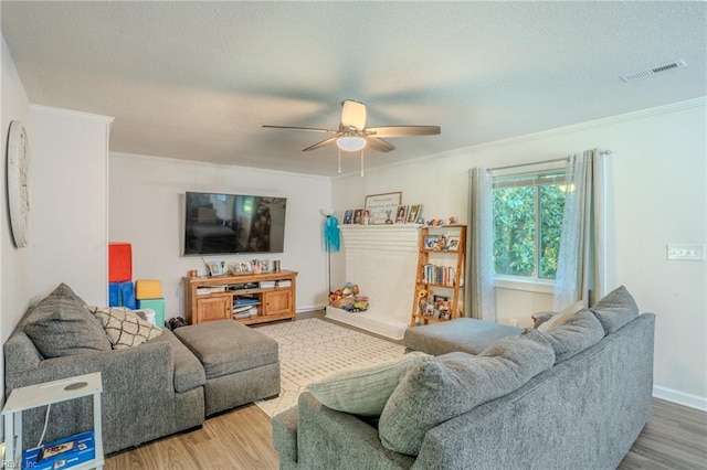 2028 Hickorywood Dr, Suffolk, VA 23434 - living room featuring crown molding, a ceiling fan, wood finished floors, and a textured ceiling