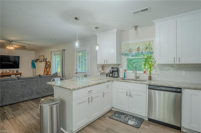 2028 Hickorywood Dr, Suffolk, VA 23434 - kitchen featuring dishwasher, a peninsula, light wood finished floors, white cabinets, and ornamental molding
