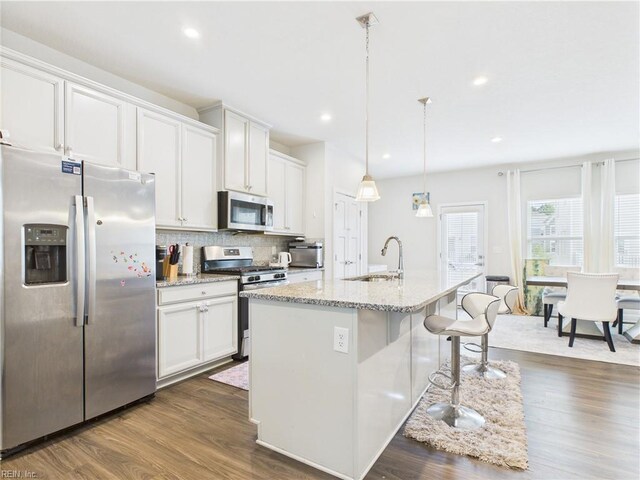 1732 Defiance Dr, Chesapeake, VA 23323 - kitchen with stainless steel appliances, dark wood finished floors, backsplash, a center island with sink, and recessed lighting