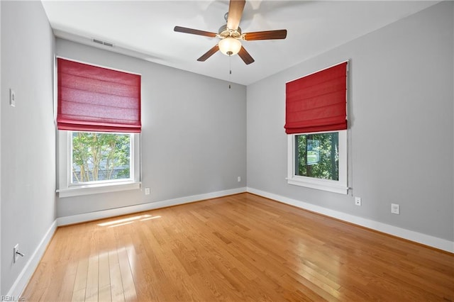 102 Batten Cv, Carrollton, VA 23314 - empty room with plenty of natural light, wood finished floors, and a ceiling fan