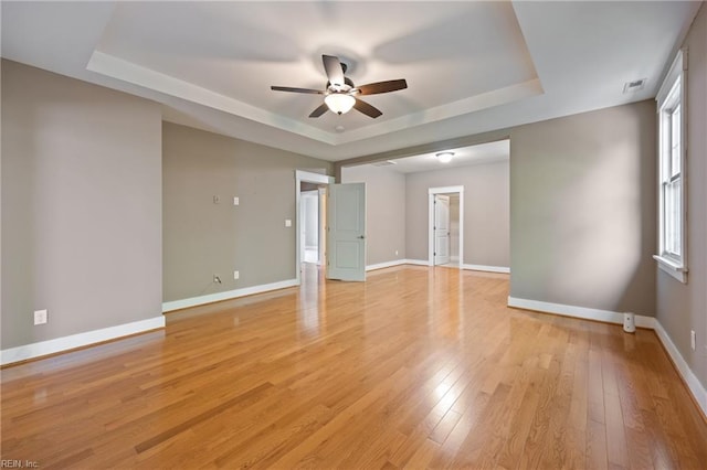 102 Batten Cv, Carrollton, VA 23314 - empty room with a tray ceiling, ceiling fan, and light wood finished floors