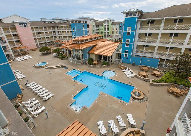 3738 Sandpiper Rd Unit 214B, Virginia Beach, VA 23456 - community pool featuring a patio
