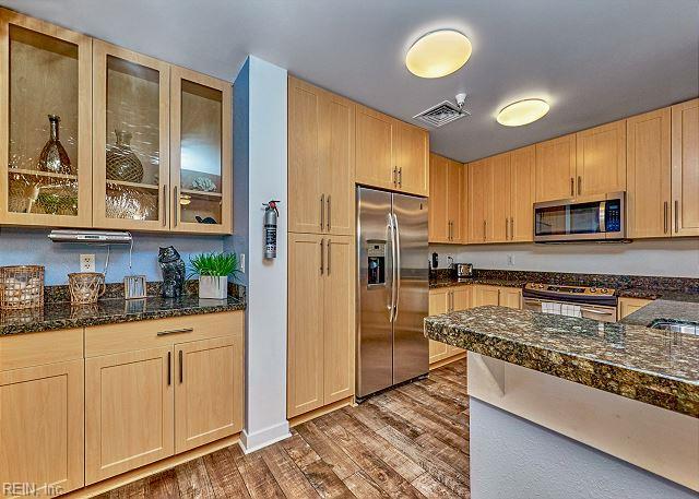 3738 Sandpiper Rd Unit 214B, Virginia Beach, VA 23456 - kitchen with appliances with stainless steel finishes, light brown cabinets, wood finished floors, and glass insert cabinets