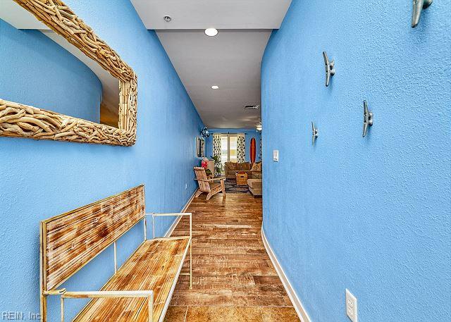 3738 Sandpiper Rd Unit 214B, Virginia Beach, VA 23456 - corridor with wood finished floors and a textured wall