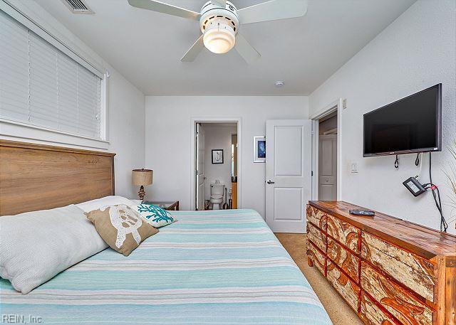 3738 Sandpiper Rd Unit 214B, Virginia Beach, VA 23456 - carpeted bedroom with a ceiling fan and ensuite bathroom