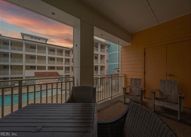 3738 Sandpiper Rd Unit 214B, Virginia Beach, VA 23456 - balcony at dusk with view of pool area