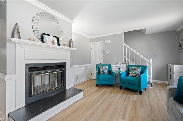 2025 Allison Dr, Chesapeake, VA 23325 - living room with wood finished floors, a glass covered fireplace, stairs, and crown molding