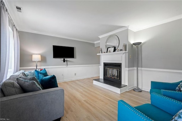 2025 Allison Dr, Chesapeake, VA 23325 - living room with wood finished floors, ornamental molding, a glass covered fireplace, and wainscoting