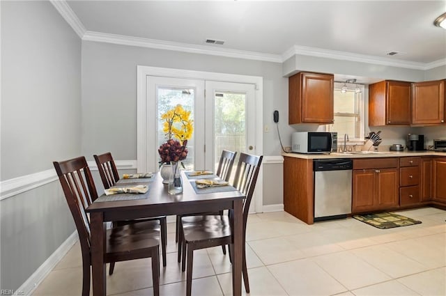 2025 Allison Dr, Chesapeake, VA 23325 - kitchen featuring appliances with stainless steel finishes, brown cabinetry, ornamental molding, light countertops, and light tile patterned floors