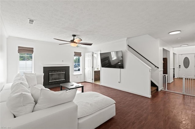 730 Kings Ridge Dr, Newport News, VA 23608 - living room with a textured ceiling, wood finished floors, stairs, a fireplace with flush hearth, and ceiling fan