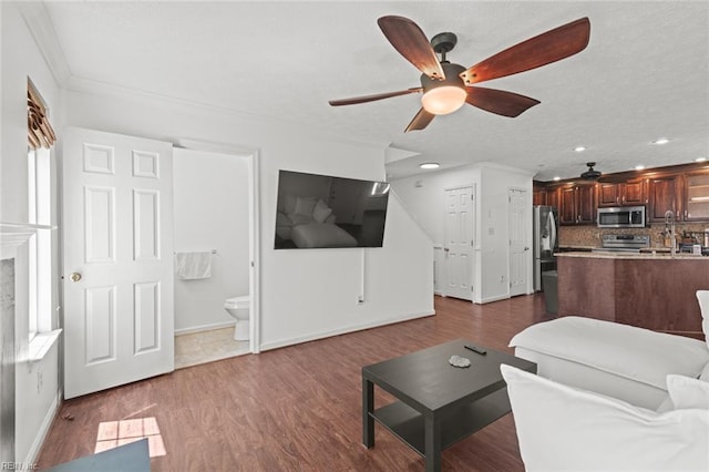 730 Kings Ridge Dr, Newport News, VA 23608 - living room featuring a ceiling fan, crown molding, dark wood finished floors, recessed lighting, and a premium fireplace