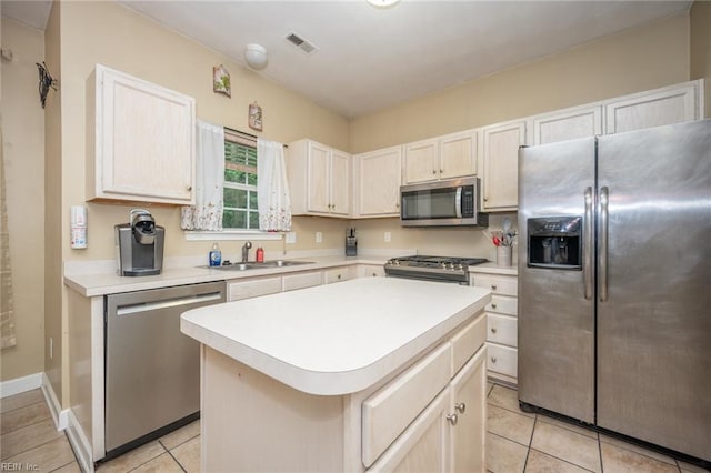 2146 Kingsley Ln, Chesapeake, VA 23323 - kitchen with appliances with stainless steel finishes, light countertops, a kitchen island, and light tile patterned flooring