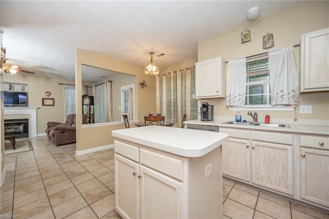 2146 Kingsley Ln, Chesapeake, VA 23323 - kitchen featuring light tile patterned flooring, a kitchen island, open floor plan, light countertops, and a fireplace