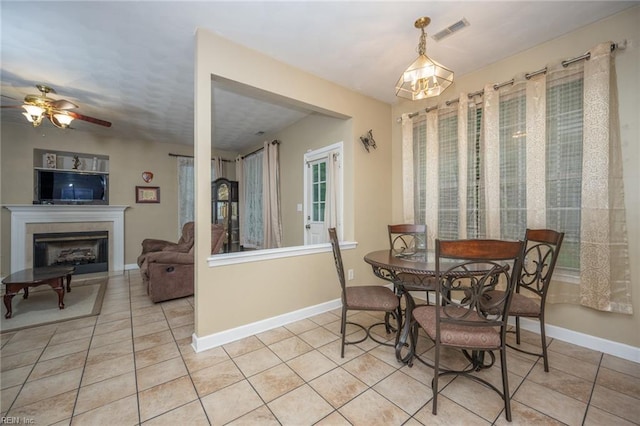 2146 Kingsley Ln, Chesapeake, VA 23323 - dining room with light tile patterned floors, a fireplace, and ceiling fan