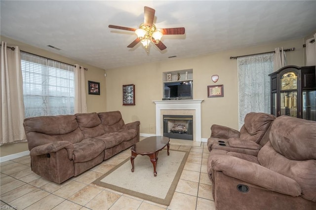 2146 Kingsley Ln, Chesapeake, VA 23323 - living room featuring a ceiling fan, a fireplace, and light tile patterned floors