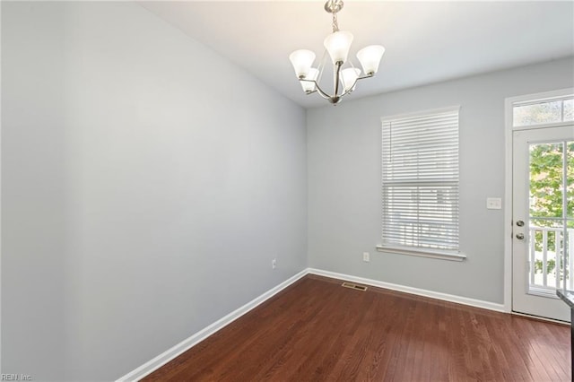 4371 Pickney Ln, Chesapeake, VA 23324 - unfurnished dining area featuring a chandelier and dark wood-type flooring