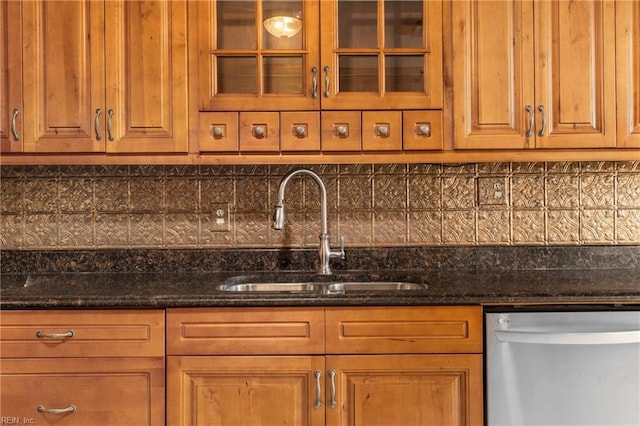160 Outlaw Ln, Suffolk, VA 23435 - kitchen with stainless steel dishwasher, tasteful backsplash, dark stone counters, glass insert cabinets, and brown cabinetry