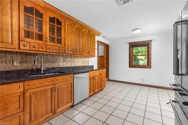 160 Outlaw Ln, Suffolk, VA 23435 - kitchen with stainless steel dishwasher, backsplash, brown cabinets, and glass insert cabinets