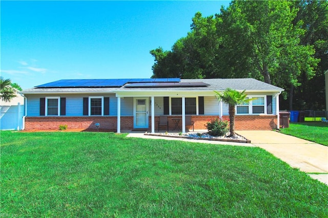 1353 King Arthur Dr, Chesapeake, VA 23323 - ranch-style home with a porch, brick siding, roof mounted solar panels, and driveway