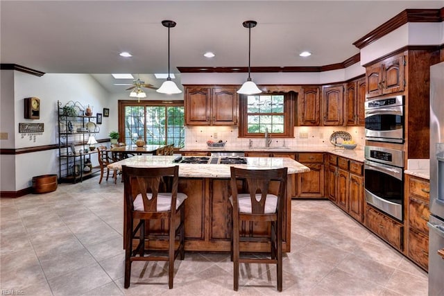 1217 Worthington Ln, Virginia Beach, VA 23464 - kitchen with plenty of natural light, decorative backsplash, a kitchen island, stainless steel double oven, and recessed lighting