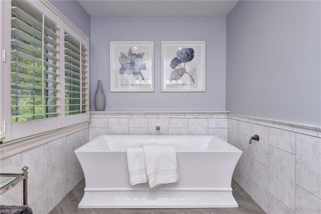 1217 Worthington Ln, Virginia Beach, VA 23464 - full bath featuring tile walls, a freestanding bath, and wainscoting