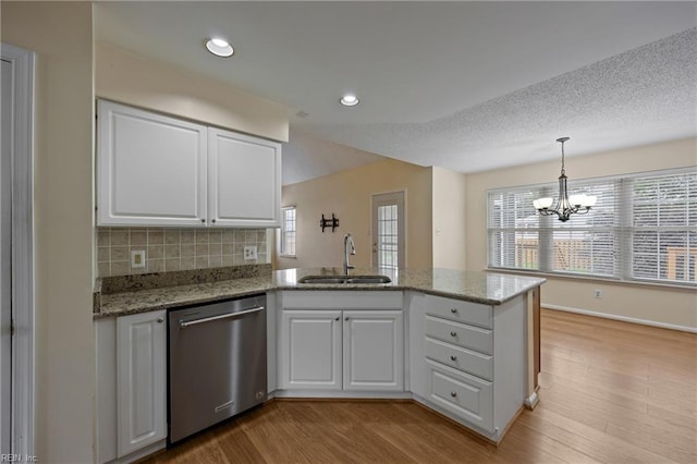 1301 Silverthorne Ct, Chesapeake, VA 23321 - kitchen featuring stainless steel dishwasher, a peninsula, white cabinets, a chandelier, and healthy amount of natural light