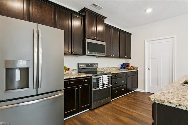 1402 Farringdon Way, Williamsburg, VA 23185 - kitchen with stainless steel appliances, dark wood-style flooring, dark brown cabinets, and light stone counters