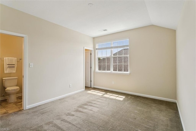 1402 Farringdon Way, Williamsburg, VA 23185 - unfurnished bedroom with carpet floors, connected bathroom, and lofted ceiling