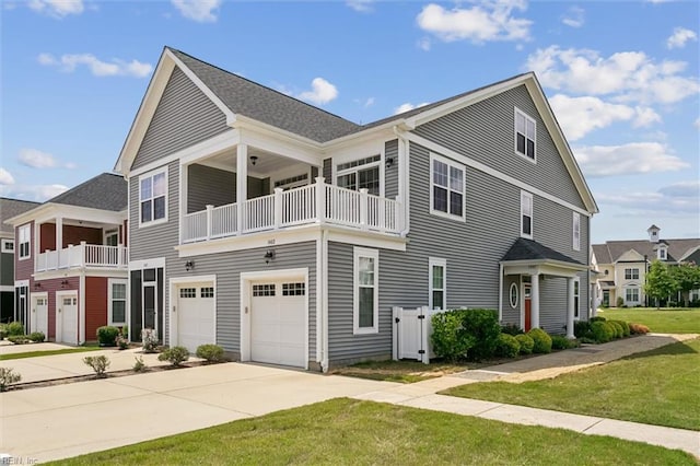 1402 Farringdon Way, Williamsburg, VA 23185 - view of property featuring a balcony, driveway, a front yard, and an attached garage