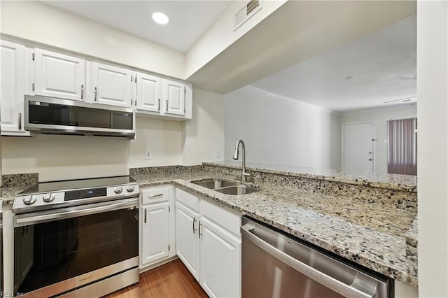 233 Mill Point Dr, Hampton, VA 23669 - kitchen featuring stainless steel appliances, light stone counters, dark wood-type flooring, white cabinetry, and crown molding