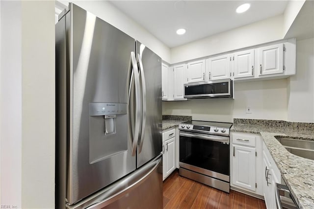 233 Mill Point Dr, Hampton, VA 23669 - kitchen featuring appliances with stainless steel finishes, white cabinets, light stone countertops, dark wood-style flooring, and recessed lighting