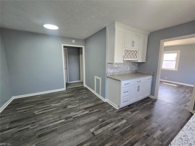 4833 Linshaw Ln, Virginia Beach, VA 23455 - kitchen featuring dark wood-style flooring, white cabinetry, light countertops, a textured ceiling, and decorative backsplash