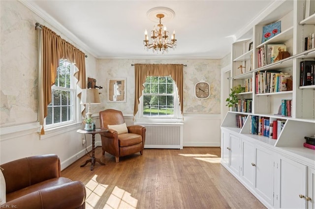 11 Elm Ave, Newport News, VA 23601 - sitting room featuring radiator, a chandelier, light wood finished floors, and ornamental molding