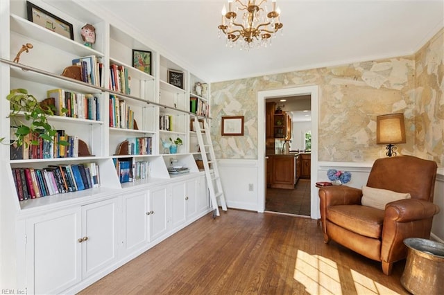 11 Elm Ave, Newport News, VA 23601 - living area with wallpapered walls, a chandelier, wainscoting, wood finished floors, and crown molding