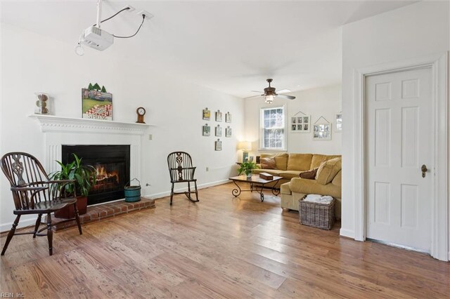 11 Elm Ave, Newport News, VA 23601 - living area featuring a brick fireplace, wood finished floors, and a ceiling fan