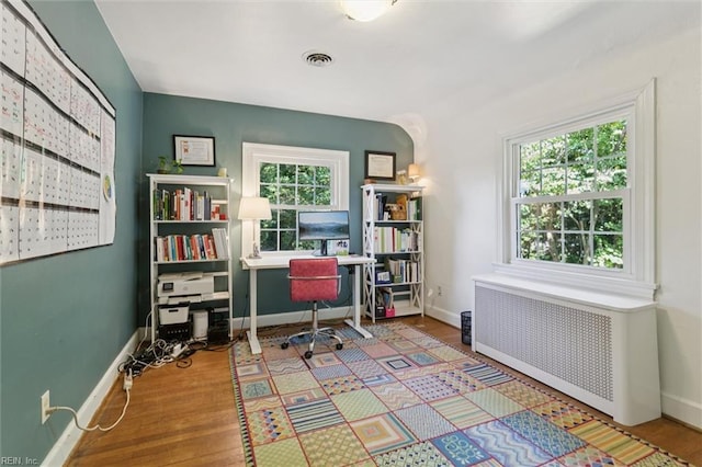 11 Elm Ave, Newport News, VA 23601 - home office with radiator heating unit, plenty of natural light, and wood finished floors